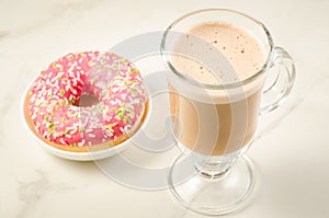 Coffee break with fresh sugary pink donut/Coffee break with fresh sugary pink donut over white marble background