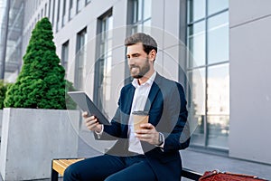 Coffee break, successful business. Glad confident attractive young caucasian guy with beard in suit