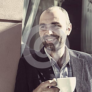 Coffee Break. Sucessful businessman enjoying in a cup of coffee photo