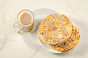 Coffee break with two fresh dry biscuit with nuts /Coffee break with two fresh dry biscuit with nuts on a white marble background