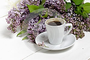 Coffee for Breakfast and lilac flowers. Selective focus