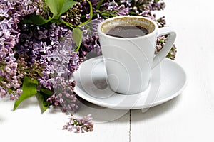 Coffee for Breakfast and lilac flowers. Selective focus