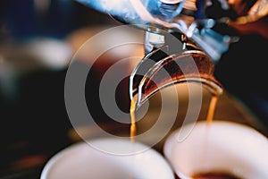 coffee brewing -espresso coffee pouring from espresso machine close up