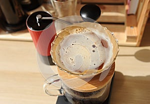 Coffee brewing in glass pour over with paper filter