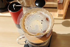 Coffee brewing in glass pour over with paper filter