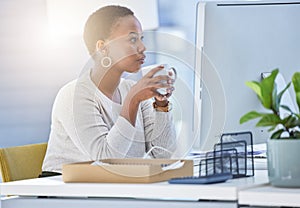 Coffee, business and black woman in office with drink reading email, report or review at desk. Computer, lens flare and