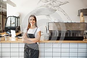 Coffee Business owner Concept - Portrait of happy attractive young beautiful caucasian barista in apron smiling at