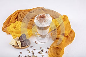 Coffee cafe latte macchiato in a high glass on a wooden background. There is copy space next to the glass photo