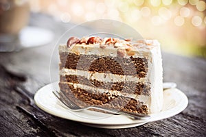 Coffee cake with almond on white plate in coffee shop.