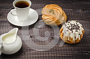 coffee with cake and milk/ breakfast: coffee with cake and milk on a dark wooden background. Copy space