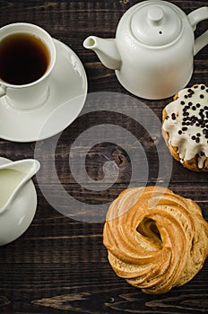 coffee with cake and milk/breakfast: coffee with cake and milk on a dark wooden background. Top view