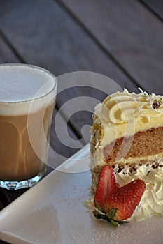 Coffee and cake slice on a wooden background - Portrait view, with room for copy