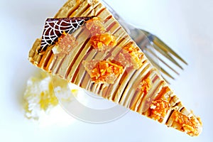 Coffee cake on the white plate and fork with soft blur whipped cream, Top view and close up