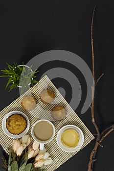 Coffee and cakes on black background.