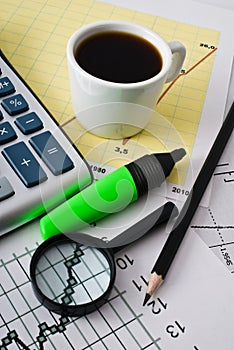 Coffee and calculator on paper table with diagram