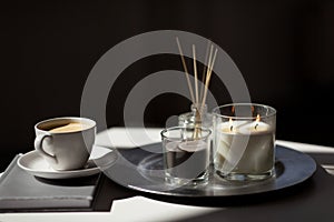 Coffee, candles and aroma reed diffuser on table