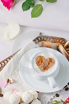 Coffee and candy in bed breakfast in hotel room.