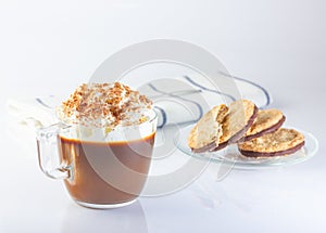 Coffee, cappuccino with whipped cream, ground nut and chocolate chips. Oatmeal cookies with chocolate. Linen napkin.