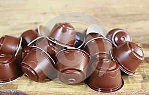 Coffee capsules on brown wooden table for espresso machine photo