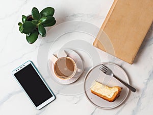 Coffee, cheescake, smartphone on tabletop