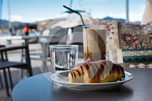 coffee and chocolate croissants, enjoyment in the port of Volos, Greece