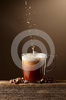Coffee and chocolate drink with cream on a brown background