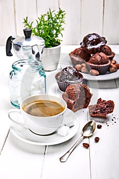 Coffee in clay cup with chocolate muffin