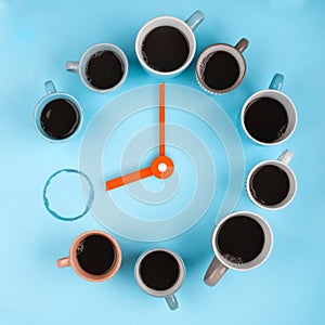 Coffee clocks. Different cups on the blue background with clock hands. Flatlay, time concept
