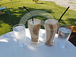 Coffee cold frape in greece summer season in a yard photo