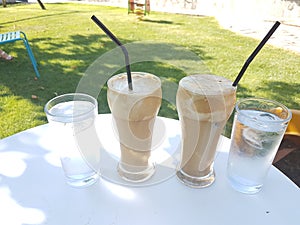 Coffee cold frape in greece summer season in a yard photo