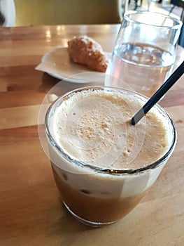 Coffee cold fredo wooden table glass of water greece photo