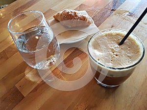 Coffee cold fredo wooden table glass of water greece