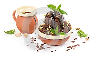 Coffee-colored ice cream with nuts and chocolate sauce