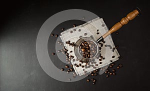 Coffee concept. Coffee beans in Cezve, hot and fresh morning coffee. Brown roasted coffee. copyspace.Flat lay. Top view photo