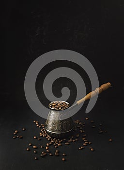 Coffee concept. Coffee beans in Cezve. on the table, hot and fresh morning coffee. Brown roasted coffee. copyspace photo