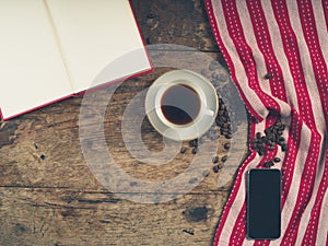 Coffee concept with cup, a book and a smart phone