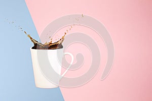 Coffee concept. Minimal art. Solid background. Coffee splashes. Levitating mug