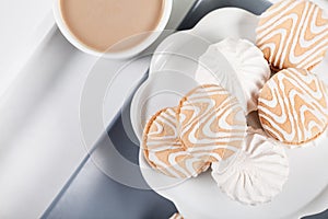 Coffee and cookies on a gray plate, top view