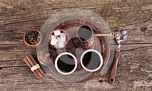 Coffee in copper coasters with accessories for coffee-drinking o