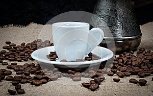 Coffee copper and white cup. Greek coffee with water and coffee pot. Turkish coffee and beans.