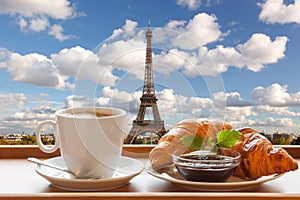 Coffee with croissants against Eiffel Tower in Paris, France photo