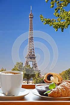 Coffee with croissants against Eiffel Tower in Paris, France