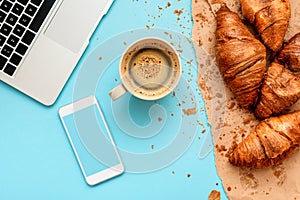 Coffee and croissants for messy breakfast in business office