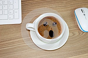 Coffee cup with astonished expression in in cream coffee