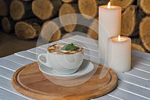 Coffee cup on bar table and romantic candles closeup