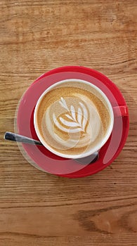 Coffee cup with barista design on froth.