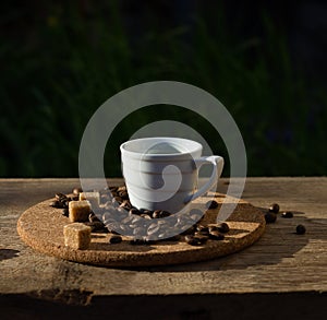 Coffee cup, beans, brown sugar on a wooden table