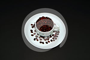 Coffee cup with coffee beans closeup shot on black background