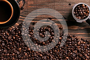 Coffee cup and beans frame on wooden table