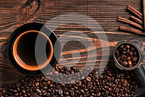 Coffee cup and beans frame on wooden table